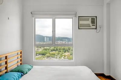 a bedroom with a bed and a large window at Superior Maya Kuala Lumpur in Kuala Lumpur