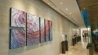 a wall with paintings on it in a shopping mall at MCity Ampang, KL in Kuala Lumpur