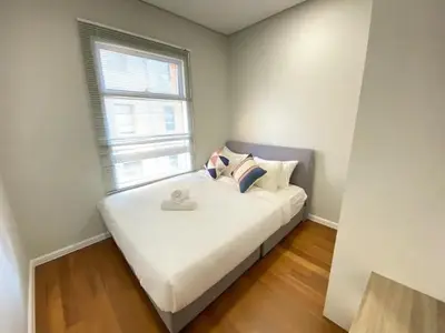 a bedroom with a white bed with a window at Sky Suites KLCC by PNUT in Kuala Lumpur