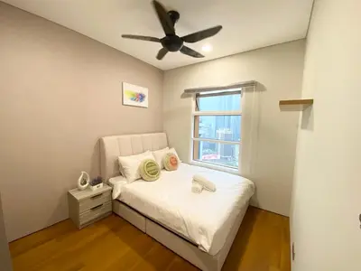 a bedroom with a bed and a ceiling fan at Sky Suites KLCC by PNUT in Kuala Lumpur