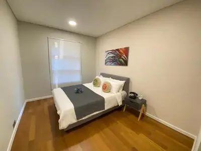 a small bedroom with a bed and a window at Sky Suites KLCC by PNUT in Kuala Lumpur