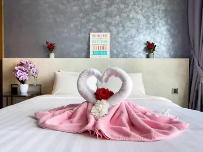 two swans made to look like hearts on a bed at The Luxury Penthouses KLCC Petronas Twin tower Kuala Lumpur in Kuala Lumpur