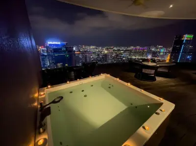 a pool table in a room with a view of a city at The Luxury Penthouses KLCC Petronas Twin tower Kuala Lumpur in Kuala Lumpur