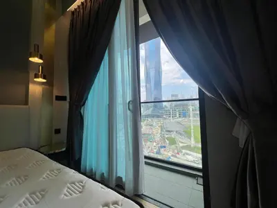 a bedroom with a window with a view of a city at Opus Residences KL Malaysia in Kuala Lumpur