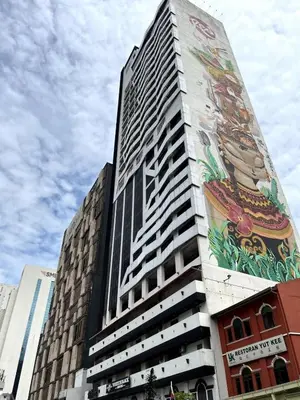 a tall building with a painting on the side of it at #16 M101 Dang Wangi KLCC View Pool By Livin in Kuala Lumpur