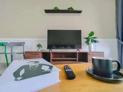 a table with a coffee cup and a box and a remote control at M Vertica By Minsu in Kuala Lumpur