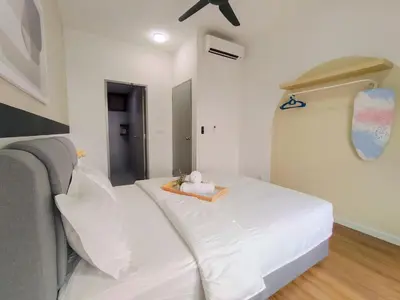 a white bed in a room with a ceiling fan at M Vertica By Minsu in Kuala Lumpur