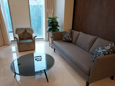 a living room with a couch and a glass table at Kuala Lumpur City Center Tropicana The Residence in Kuala Lumpur