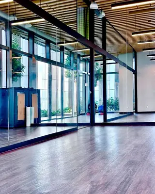 a large empty room with glass windows and a wooden floor at Kuala Lumpur City Center Tropicana The Residence in Kuala Lumpur