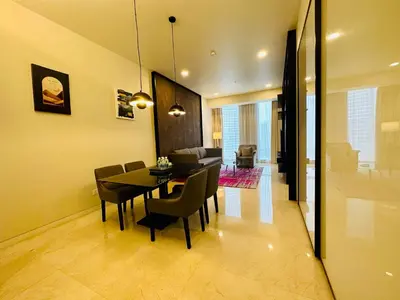 a dining room and living room with a table and chairs at Kuala Lumpur City Center Tropicana The Residence in Kuala Lumpur