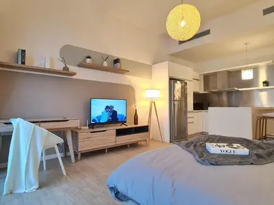 a living room with a television on a wooden table at M city service suite KLCC in Kuala Lumpur