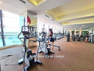 a woman in a gym with cardio machines at M city service suite KLCC in Kuala Lumpur