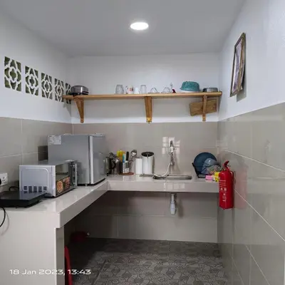a kitchen with a sink and a microwave at Cheras Homestay Family room with Private Bathroom in Kuala Lumpur