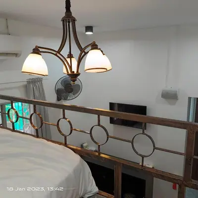a bed with two lights on top of it at Cheras Homestay Family room with Private Bathroom in Kuala Lumpur