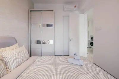a bedroom with a bed with a stuffed animal on it at Muji Home 2BR 4Pax Southlink Nexus Bangsar South in Kuala Lumpur