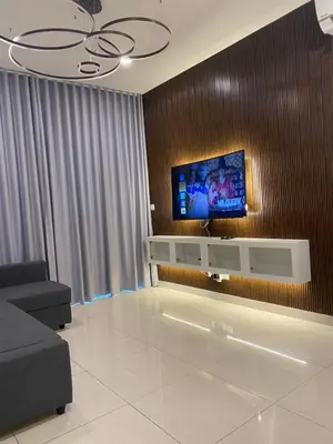 a living room with a flat screen tv on a wall at Datum Jelatek Sky Residence KLCC SkyRing Linked to LRT and Mall in Kuala Lumpur