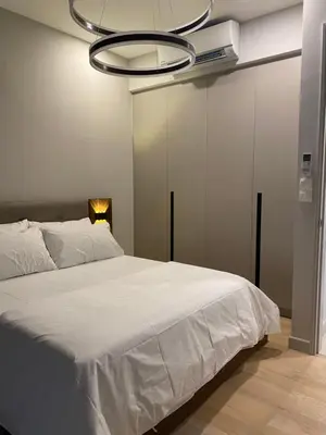 a bedroom with a large white bed and a chandelier at Datum Jelatek Sky Residence KLCC SkyRing Linked to LRT and Mall in Kuala Lumpur