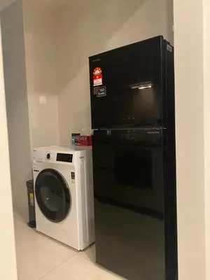 a kitchen with a washing machine and a microwave at Datum Jelatek Sky Residence KLCC SkyRing Linked to LRT and Mall in Kuala Lumpur
