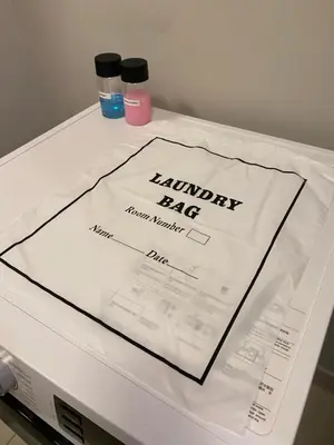 a white table with a laundry bag on it at Datum Jelatek Sky Residence KLCC SkyRing Linked to LRT and Mall in Kuala Lumpur