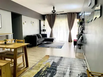 a living room with a table and a couch at Suasana Stay & Homestay Sentul Utama Kuala Lumpur 3R3BR 2AC 2 Car park-Netflix-WIFI-Pool View in Kuala Lumpur