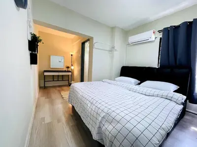a bedroom with a bed and a desk in it at Suasana Stay & Homestay Sentul Utama Kuala Lumpur 3R3BR 2AC 2 Car park-Netflix-WIFI-Pool View in Kuala Lumpur
