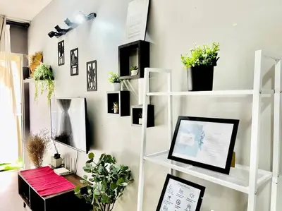 a room with a white shelf with plants on it at Suasana Stay & Homestay Sentul Utama Kuala Lumpur 3R3BR 2AC 2 Car park-Netflix-WIFI-Pool View in Kuala Lumpur