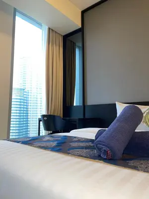 a hotel room with a bed with a large window at Tropicana The Residences By RS in Kuala Lumpur