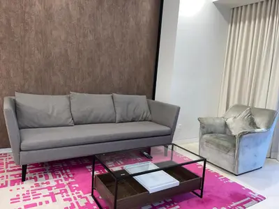 a living room with a couch and a chair at Tropicana The Residences By RS in Kuala Lumpur