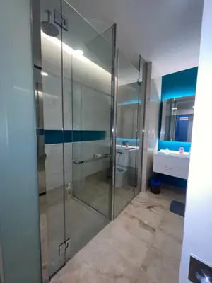 a glass shower in a bathroom with a sink at Tropicana The Residences By RS in Kuala Lumpur