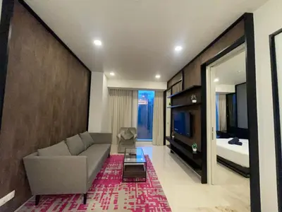 a living room with a couch and a bed at Tropicana The Residences By RS in Kuala Lumpur