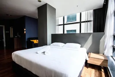 a bedroom with a large white bed with a large window at Bangsar Trade Centre by Airhost in Kuala Lumpur
