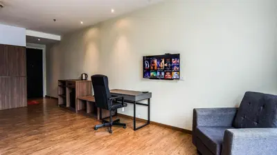 a room with a desk and a chair and a couch at Bangsar Trade Centre by Airhost in Kuala Lumpur