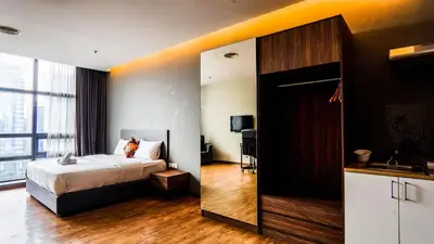 a hotel room with a bed and a mirror at Bangsar Trade Centre by Airhost in Kuala Lumpur