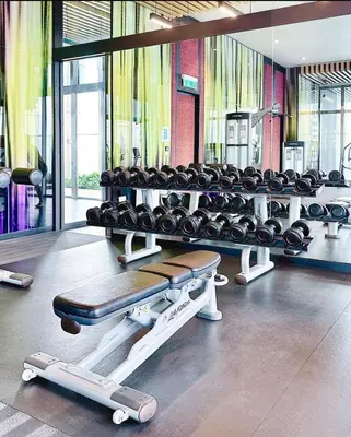 a gym with a row of dumbbells on display at Tropicana The Residence Klcc By Sky World in Kuala Lumpur