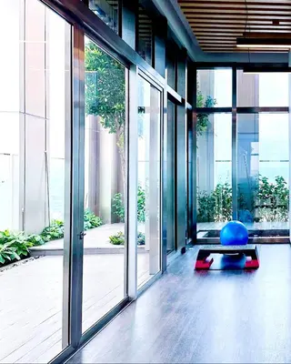 an office with a large glass door and a yoga ball at Tropicana The Residence Klcc By Sky World in Kuala Lumpur