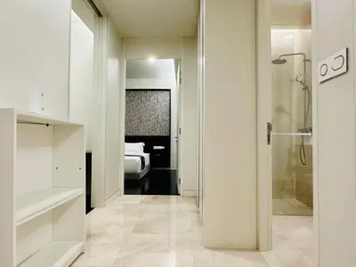 a bathroom with a walk in shower and a bedroom at Tropicana The Residence Klcc By Sky World in Kuala Lumpur