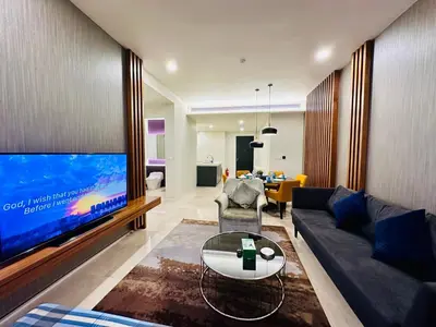 a living room with a large flat screen tv at Tropicana The Residence Klcc By Sky World in Kuala Lumpur