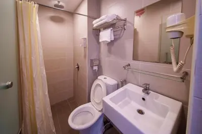 a bathroom with a toilet and a sink at Uptown Chinatown in Kuala Lumpur