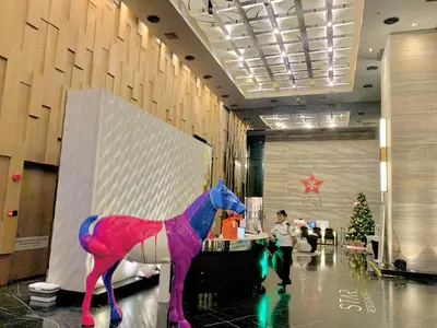 a large pink and purple horse in a lobby at Star Sky Park KLCC in Kuala Lumpur