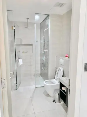 a white bathroom with a shower and a toilet at Star Sky Park KLCC in Kuala Lumpur