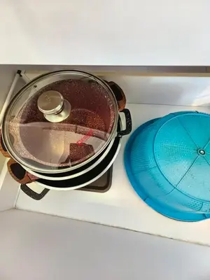 a pan sitting on top of a stove with a blue plate at Summer Suites by Moon Orchid in Kuala Lumpur