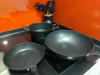 two pans sitting on top of a stove at Arcoris Soho 1-4PAX COZY HOME in Kuala Lumpur