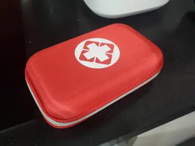 a red case with a star on it sitting on a table at Arcoris Soho 1-4PAX COZY HOME in Kuala Lumpur