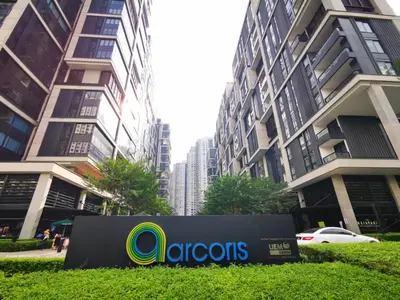 a sign in front of some tall buildings at Arcoris Soho 1-4PAX COZY HOME in Kuala Lumpur