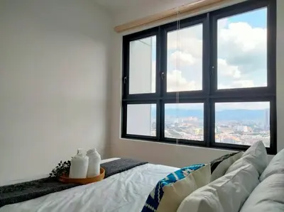 a living room with a couch and a large window at M Vertica Residence I HomeBrickz in Kuala Lumpur