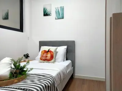 a bedroom with a bed with a pumpkin pillow on it at M Vertica Residence I HomeBrickz in Kuala Lumpur
