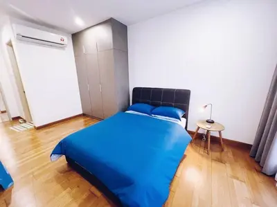 a bedroom with a blue bed and a wooden floor at [PROMO]Connected train 2 Bedroom ABOVE MALL (22) in Kuala Lumpur