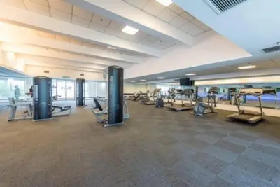 a gym with treadmills and machines in a building at MITEC Publika 500Mbp Wi-fi Studio Mont Kiara Hartamas in Kuala Lumpur