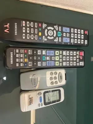 a group of remote controls sitting on a shelf at Kuala Lumpur Bukit Bintang LaLaport Serviced Suite KLCC in Kuala Lumpur
