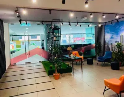 a room with a table and chairs in a building at Kuala Lumpur Bukit Bintang LaLaport Serviced Suite KLCC in Kuala Lumpur